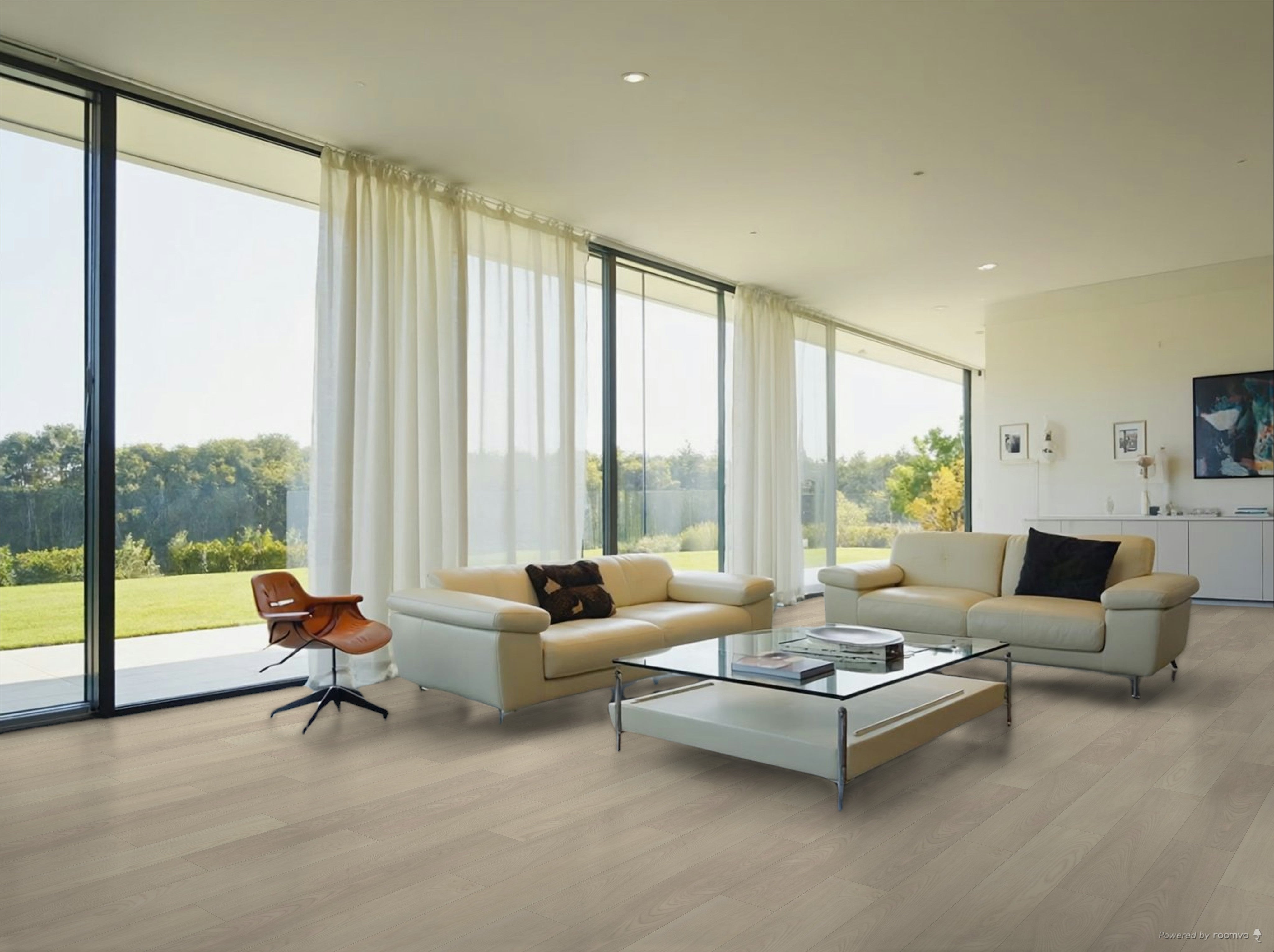 Bright modern living room with large glass windows, cream sofas, a glass coffee table, and elegant decor, showcasing a green outdoor view.