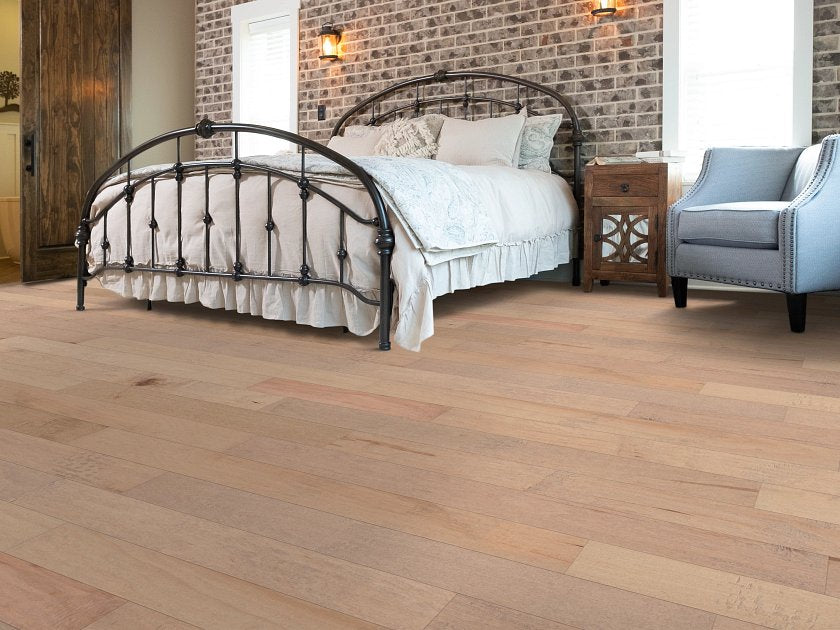 Shaw Yukon Maple 5 Smoke Lg engineered hardwood flooring gives this living room a polished look, with natural wood color around sofa seating and the open floor area.