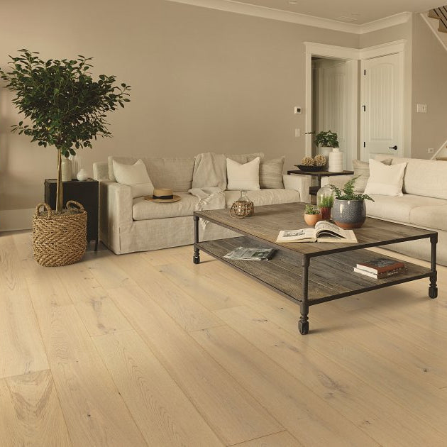 Shaw Expressions 9.5 Lyric engineered hardwood flooring gives this living room a polished look, with natural wood color around sofa seating and the open floor area.
