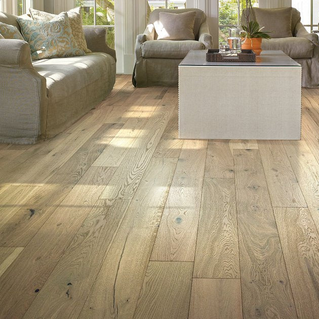 Shaw Ensemble Crema engineered hardwood flooring gives this living room a calm look, with light creamy oak color around sofa seating and the open floor area.