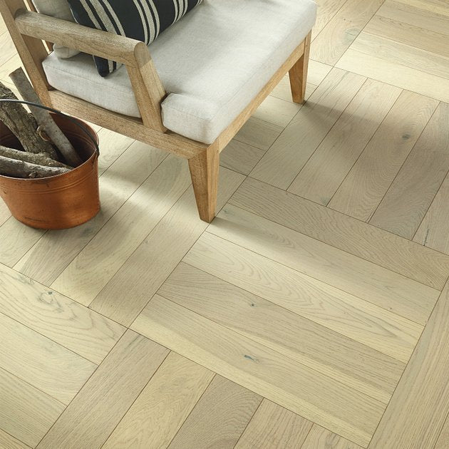 Shaw Empire Oak Herringbone Carnegie engineered hardwood flooring photographed in a living room, pairing natural wood hardwood with the furniture layout.