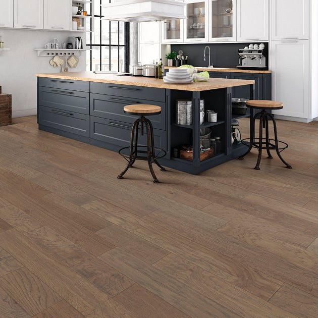 Shaw Arbor Place Stepping Stone engineered hardwood flooring shown across a kitchen, highlighting a soft neutral hardwood look.