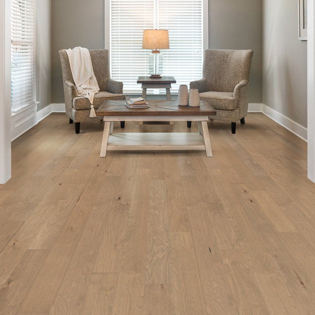Shaw Biscayne Bay Seagrass engineered hardwood flooring shapes this living room with natural wood color around sofa seating and the open floor area.