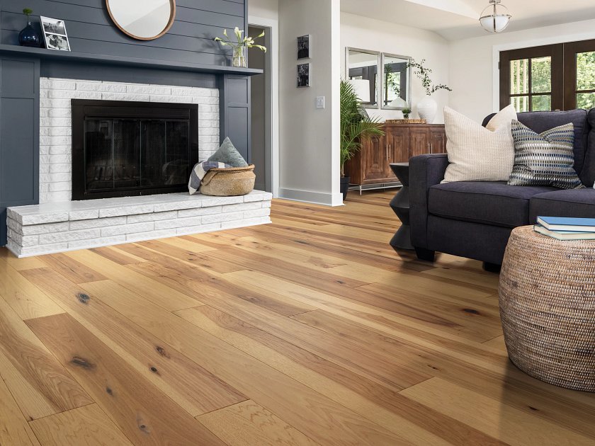 Shaw Sanctuary Hickory Reunion engineered hardwood flooring photographed in a living room, pairing natural wood hardwood with sofa seating and the open floor area.