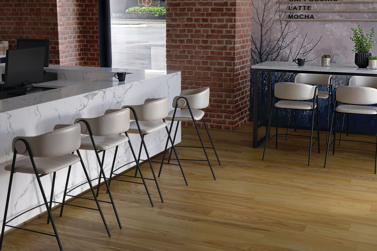 Industrial counter with a marble counter, brick walls and Native Natural planks from Armstrong TimberTones LM22A-223W