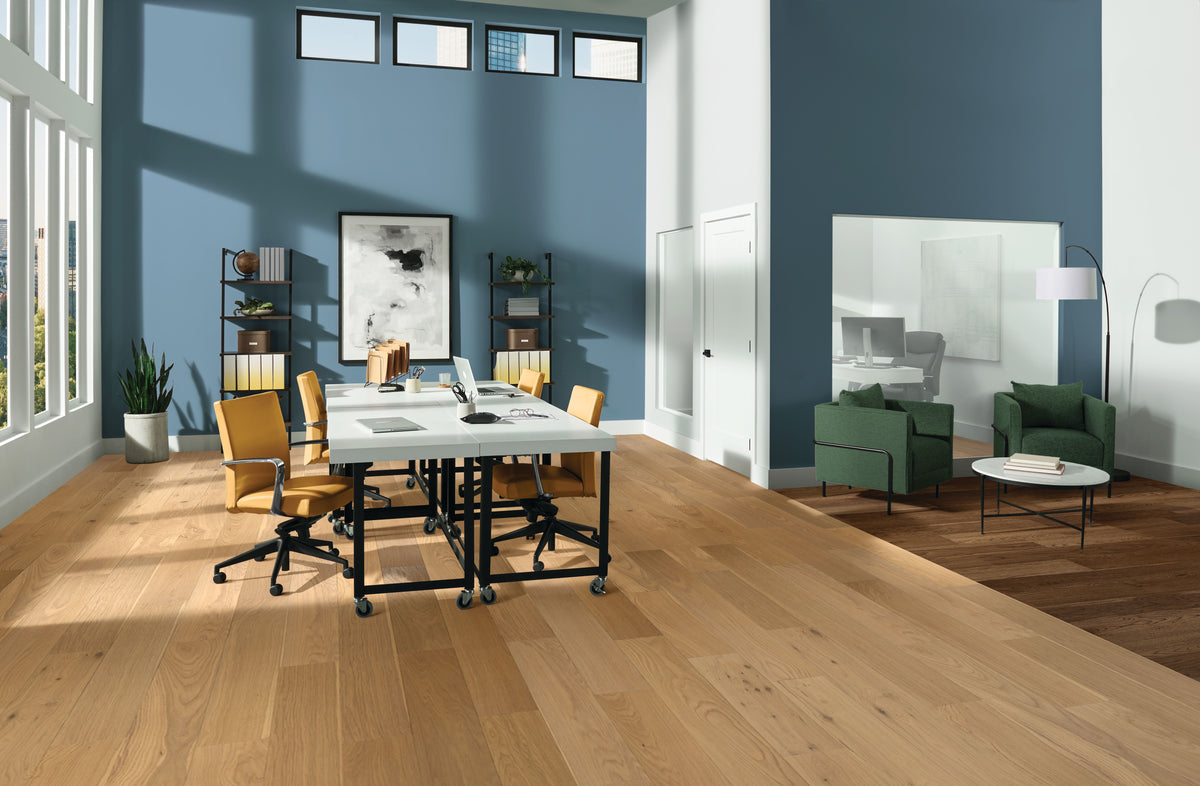 Blue-walled conference room with deep Russet Reverie planks beside a lighter wood floor from Armstrong TimberTones SKU EK7LD687W.