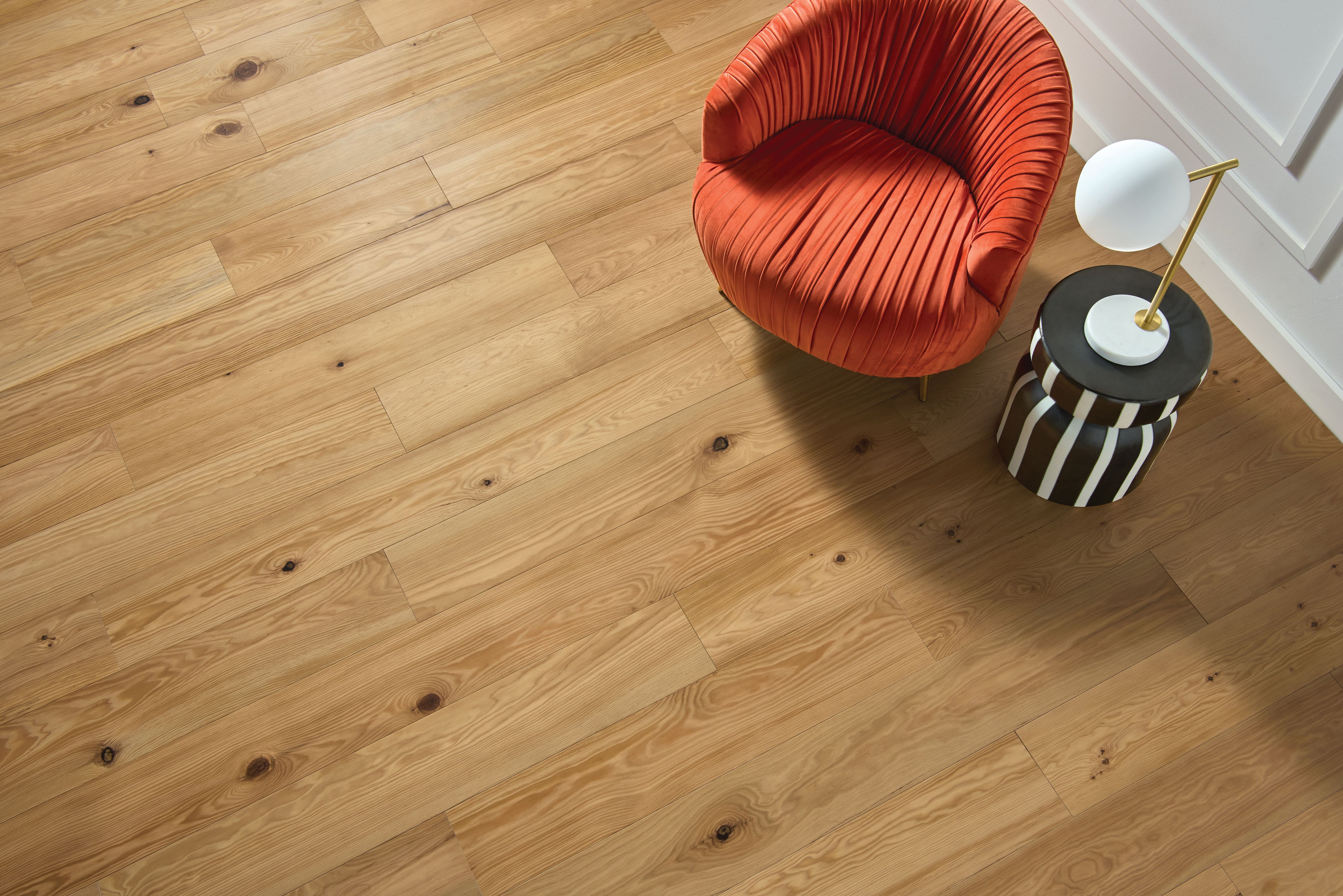 Overhead reading corner with an orange chair on golden Sunny Natural planks from Armstrong flooring LM19P-556S.