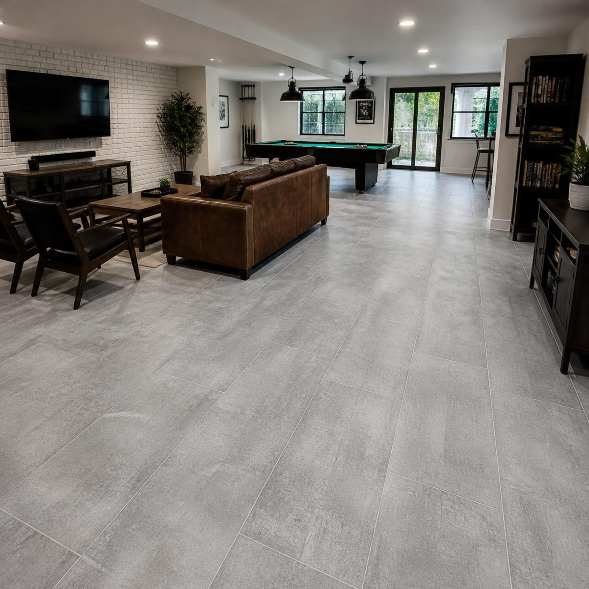 Family game room with a pool table, leather sofa, TV, and dark wood dining set, featuring Armstrong Alterna Grain Directions Mountain Fog D7362 luxury vinyl tile, 12 × 24 inches. floorcity.com