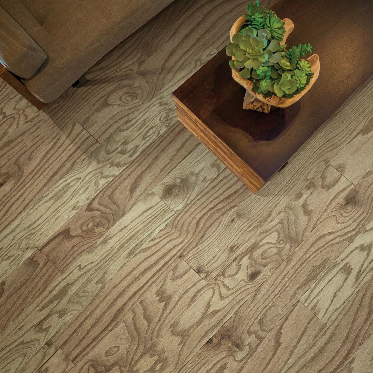 Shaw Eclectic Oak Art Deco engineered hardwood flooring in a living room, where natural wood wood tones sit naturally with sofa seating and the open floor area.