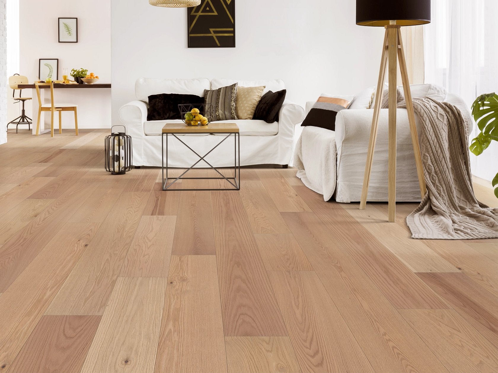 Shaw Landmark Sliced Oak Bandelier engineered hardwood flooring shapes this living room with natural wood color around sofa seating and the open floor area.
