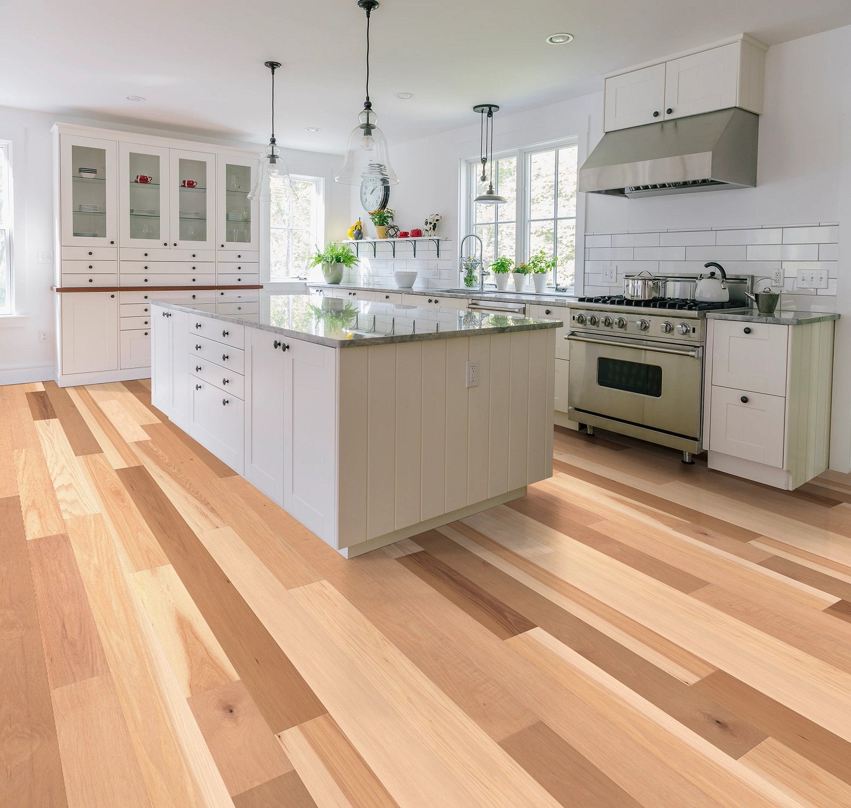 Shaw Natural Classics Hickory engineered hardwood flooring in a living room, where brown wood tones sit naturally with sofa seating and the open floor area.
