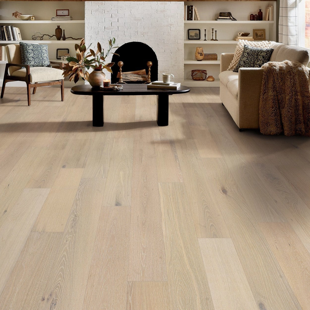 Living room view of Shaw Cornerstone II Cotton engineered hardwood flooring, showing natural wood hardwood color near sofa seating and the open floor area.