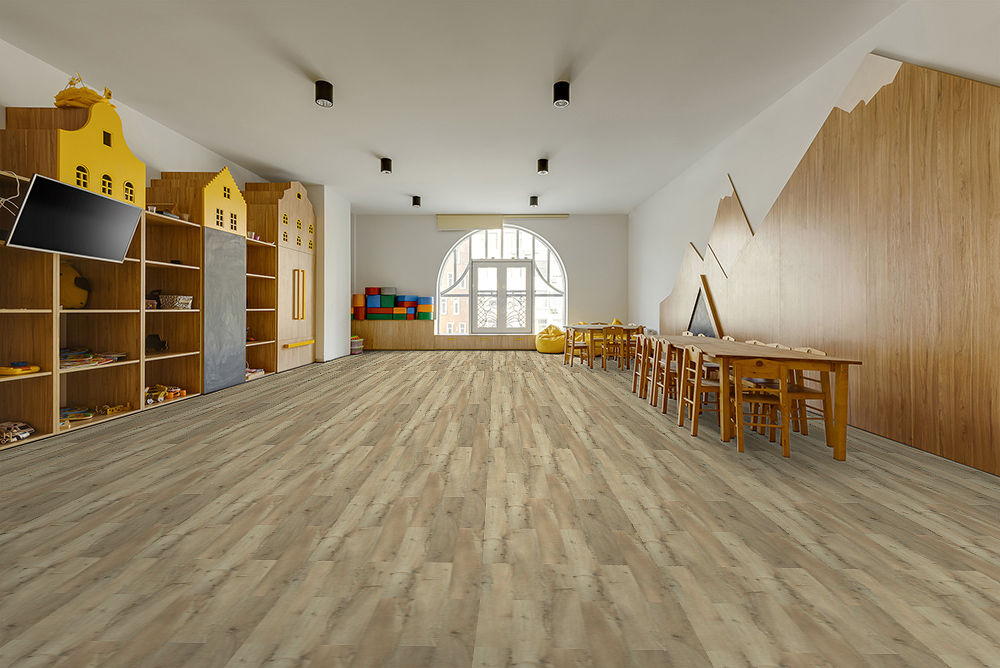 Bright classroom with light wood-look flooring, wooden furniture, and a large window letting in natural light.