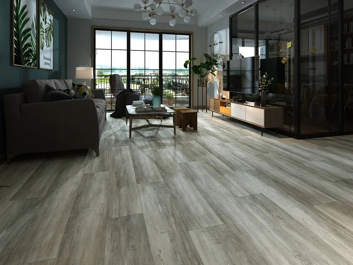 Modern living room with Stanton Floors 2000 Exotica 306 SPC luxury vinyl plank flooring in a light gray wood look.