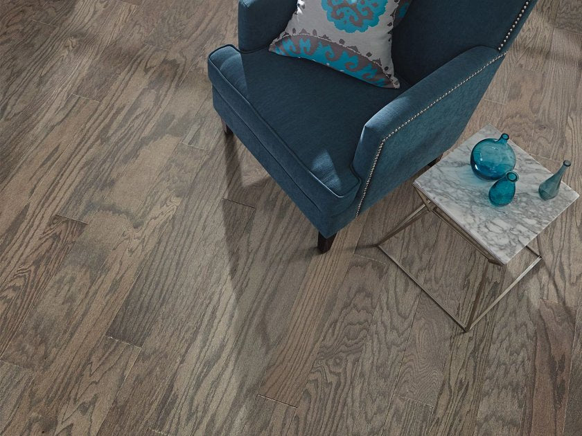 Shaw Timeless Oak 5 Weathered engineered hardwood flooring photographed in a living room, pairing natural wood hardwood with sofa seating and the open floor area.