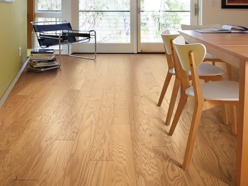Shaw Albright Oak 5.0 Caramel engineered hardwood flooring shown across a study room, highlighting a honey caramel hardwood look.