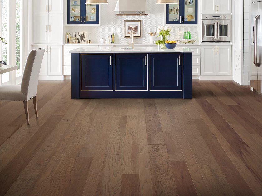 Living room view of Shaw Pebble Hill Hickory Mixed Width Cassia Bark engineered hardwood flooring, showing natural wood hardwood color near the furniture layout.
