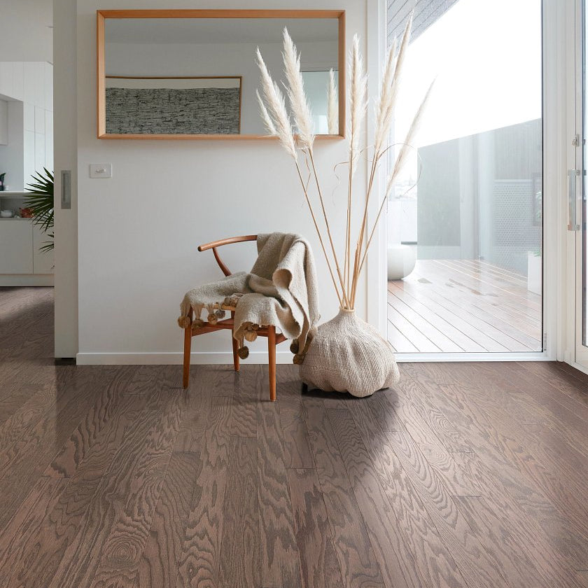 Shaw Albright Oak 3.25 Kona Lg engineered hardwood flooring shapes this living room with natural wood color around sofa seating and the open floor area.