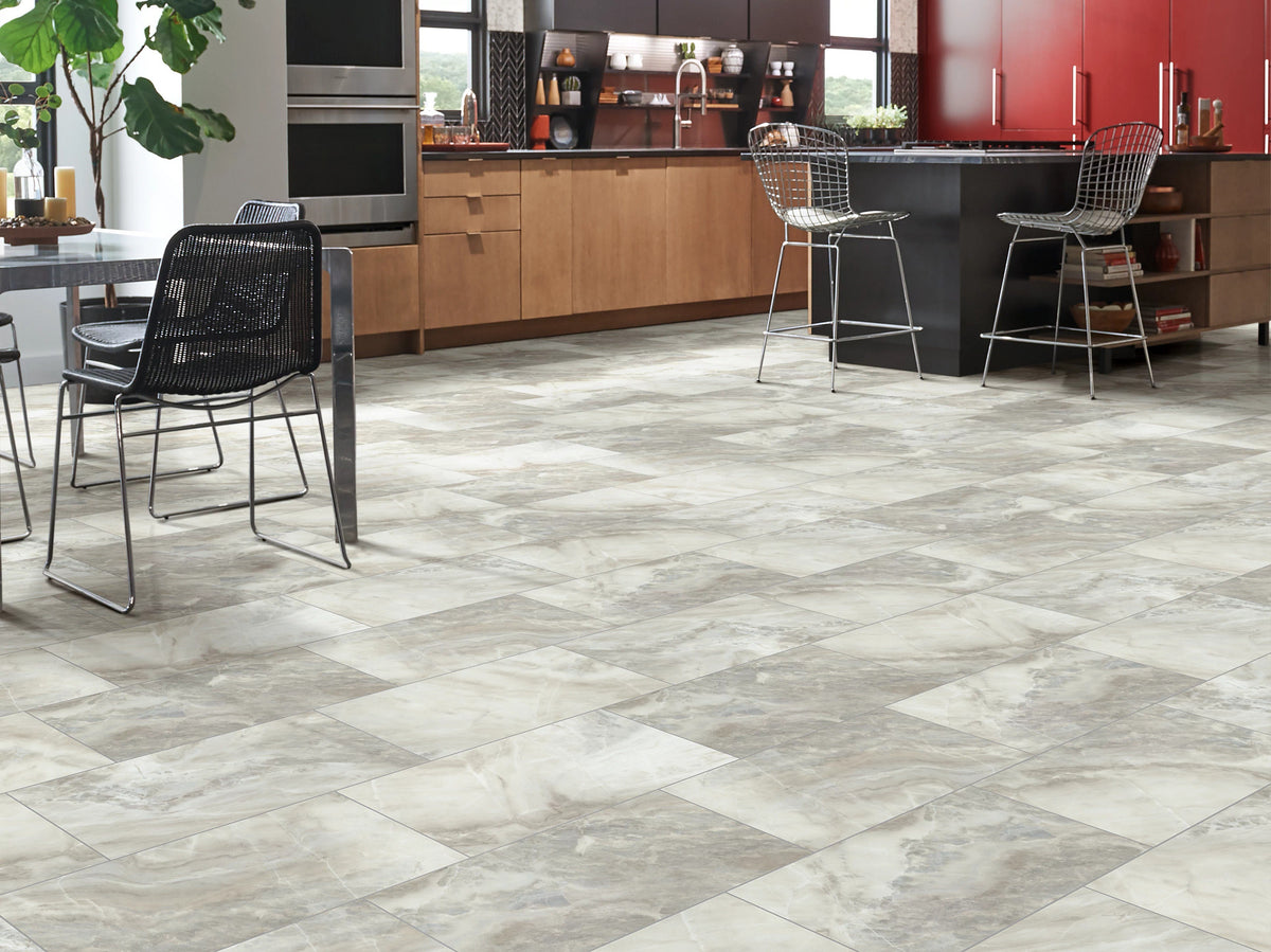 Wire bar chairs, red upper cabinets and natural wood fronts create a modern kitchen around White Onyx 1022V-01101 flooring from Shaw Paragon Tile Plus.