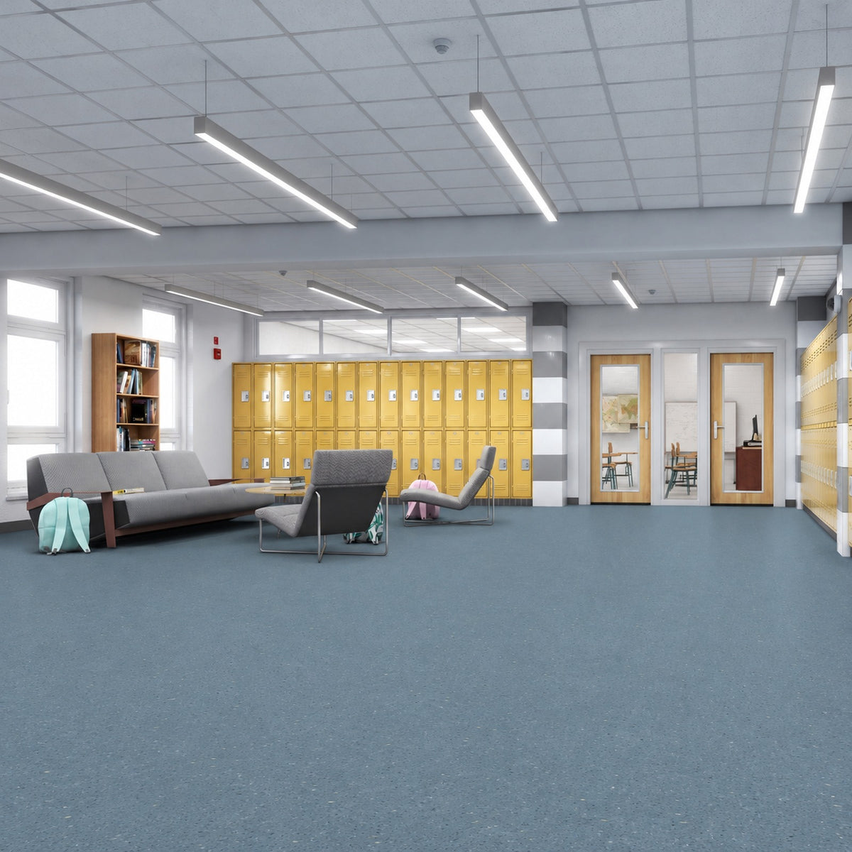 Armstrong Medintone Aegean Blue sheet vinyl, a muted slate blue with fine light flecks, in a school commons with yellow lockers, gray lounge seating and classroom doors.