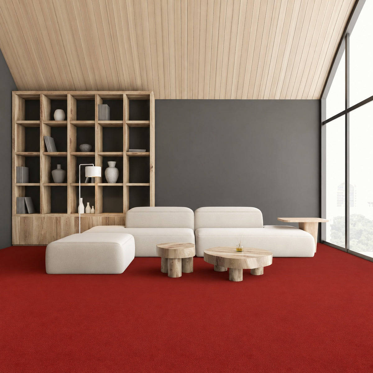 Armstrong Medintone Canyon Blaze sheet vinyl, a bold red with a soft mottled texture, in a lounge with a cream modular sofa, wood shelving and floor-to-ceiling windows.