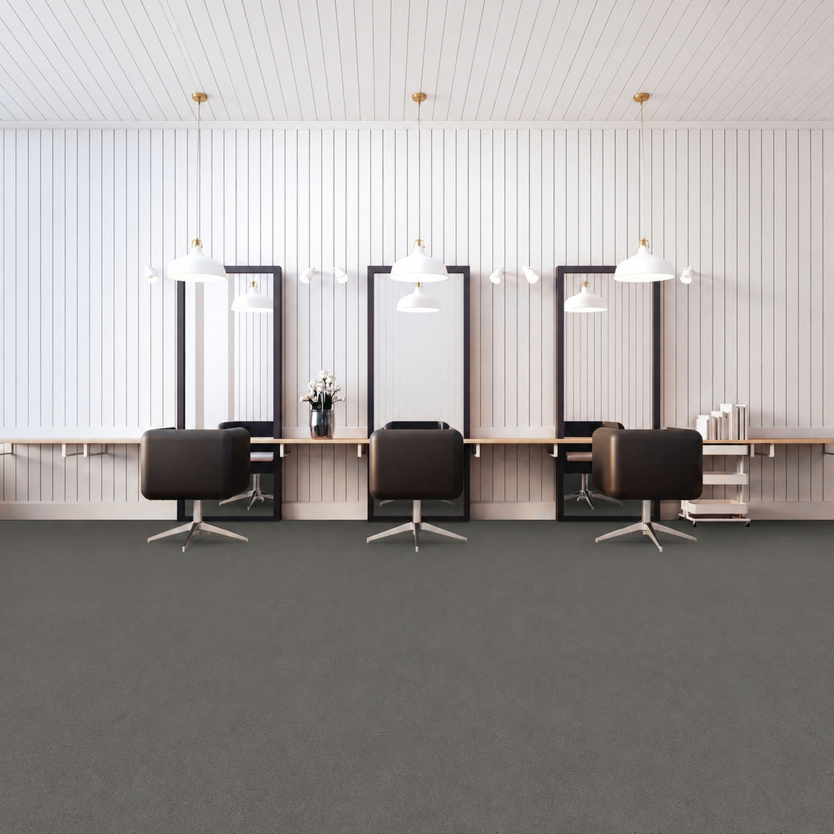 Armstrong Medintone Cool Evening sheet vinyl, a dark charcoal gray with a fine speckle, in a hair salon with three styling chairs and tall mirrors against a white paneled wall.