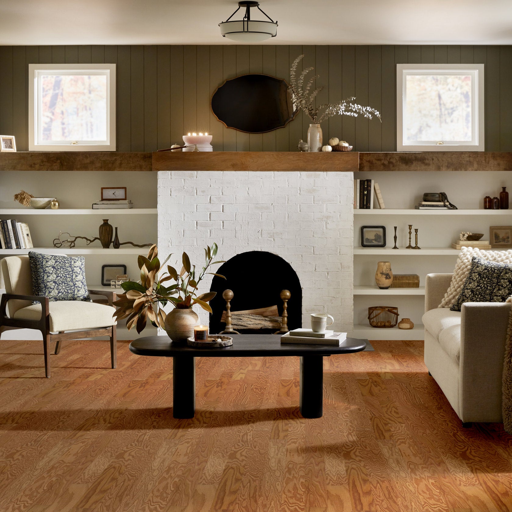 Living room view of Shaw Albright Oak 3.25 Caramel engineered hardwood flooring, showing natural wood hardwood color near the furniture layout.