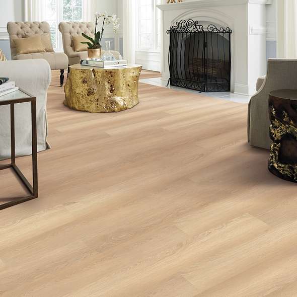 Sandy beige Shaw Endura Plus White Sand 0736V-02013 wood-look vinyl stretches around a white fireplace and upholstered living-room seating.