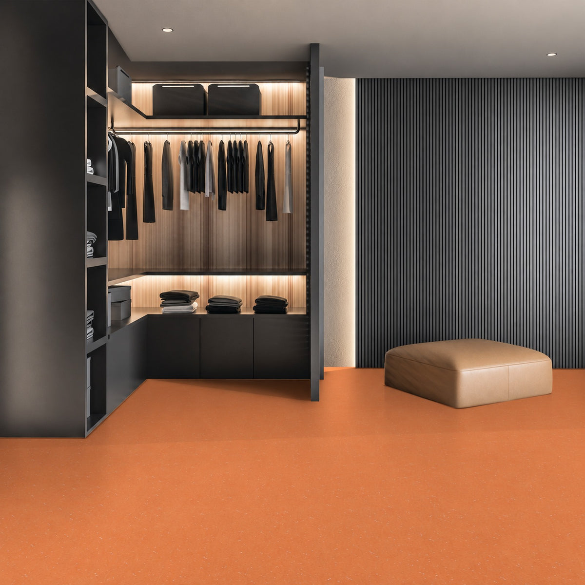 Armstrong Medintone Tangelo sheet vinyl, a bright orange with faint light flecks, in a walk-in closet with dark shelving, lit hanging rails and a leather ottoman.