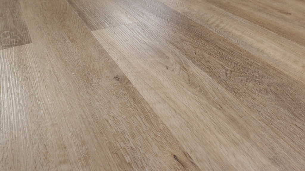Close-up of installedCOREtec Brockport Oak WPC Vinyl Plank Flooring VV023-00513 n light blonde oak tones, showing detailed wood grain and wide-plank seams.
