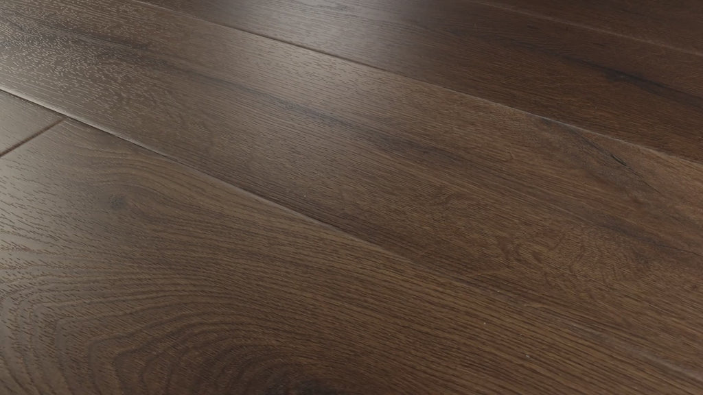 Close-up camera pans across installed COREtec Midnight Oak WPC Vinyl Plank Flooring VV810-03019, highlighting its deep espresso-brown oak tones, detailed wood grain and wide-plank layout.
