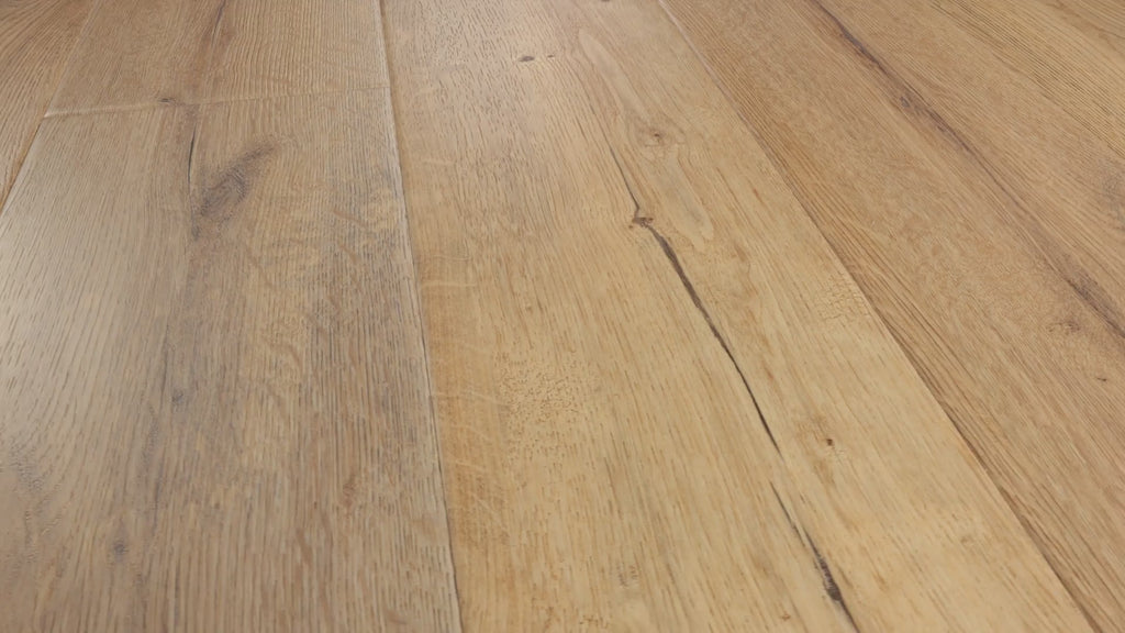 Close-up camera pans across installed COREtec Sand luxury vinyl plank flooring, highlighting its warm sandy oak tones, detailed wood grain, knots and natural plank variation.
