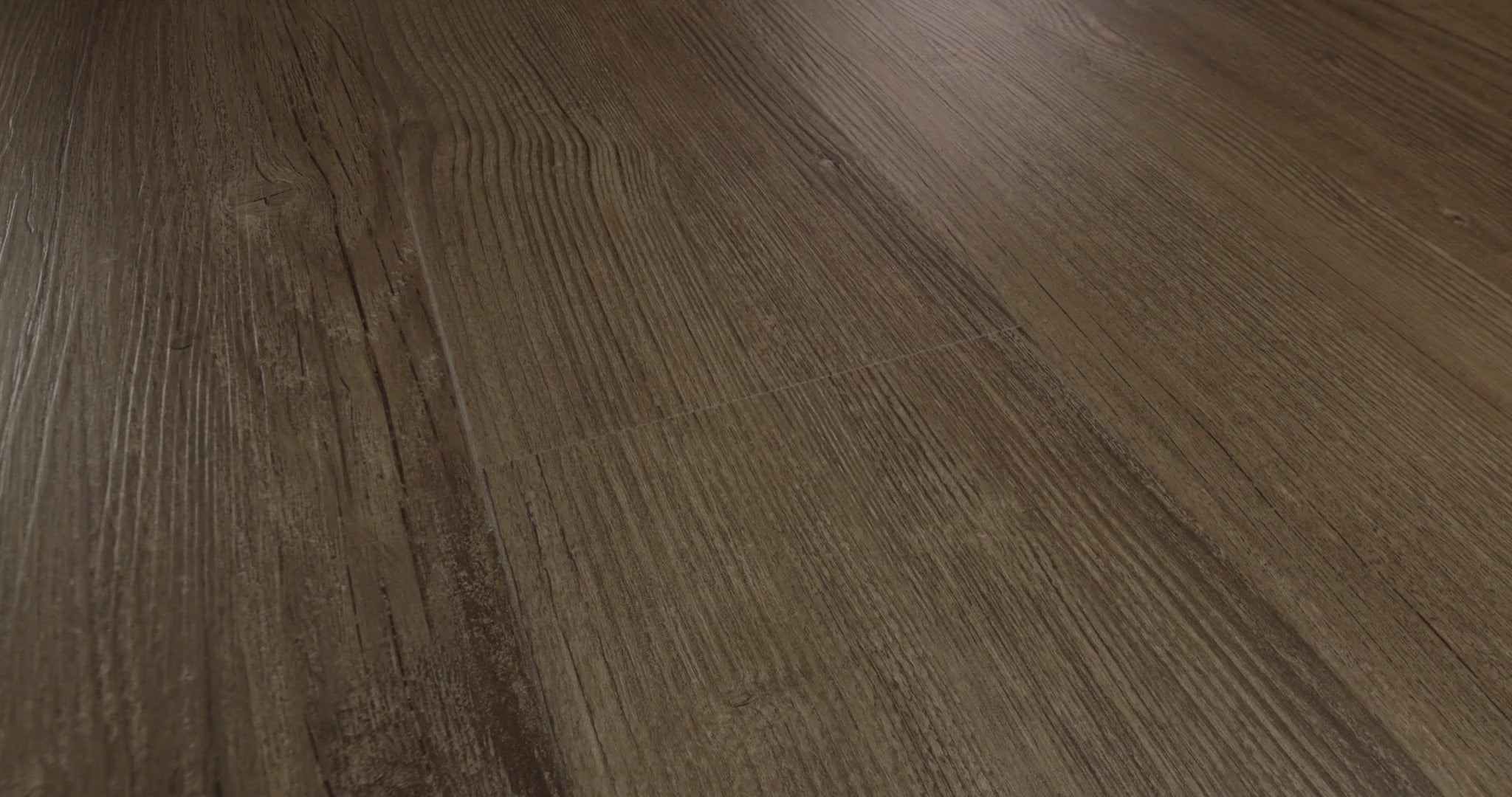 The 7-by-48-inch format of Shaw Floors Endura Plus presents a muted medium-brown wood look with elongated grain and subtle edge bevels in Casual Comfort 0736V-07294 color. Its 4.8 mm SPC vinyl construction includes a 12 mil wear layer, distinct from the overall plank thickness. Its subdued pattern is an option for organic modern and transitional rooms.