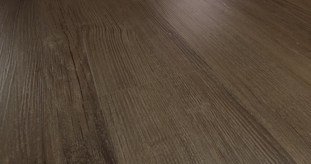 The 7-by-48-inch format of Shaw Floors Endura Plus presents a muted medium-brown wood look with elongated grain and subtle edge bevels in Casual Comfort 0736V-07294 color. Its 4.8 mm SPC vinyl construction includes a 12 mil wear layer, distinct from the overall plank thickness. Its subdued pattern is an option for organic modern and transitional rooms.