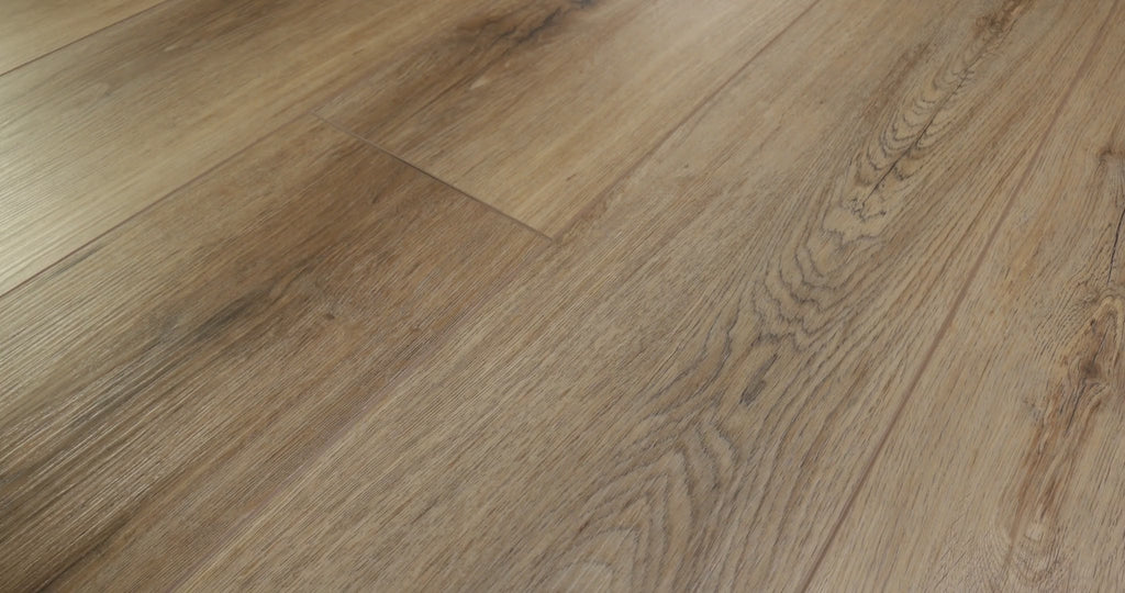 Small dark knots and elongated grain details appear across the tan-brown Shaw Paladin Plus Wild Dunes (0278V-07089) poster, with adjacent vinyl boards showing different shades.