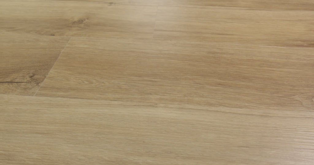 Flowing wood-look grain and scattered dark knots cross the sandy tan planks of Shaw Endura Plus Marina. Embossing and micro-beveled edges define its 7-inch-wide, 48-inch-long format. The 4.8 mm SPC plank includes an attached EVA pad for underfoot comfort. Its warm neutral appearance can complement coastal and transitional interiors.