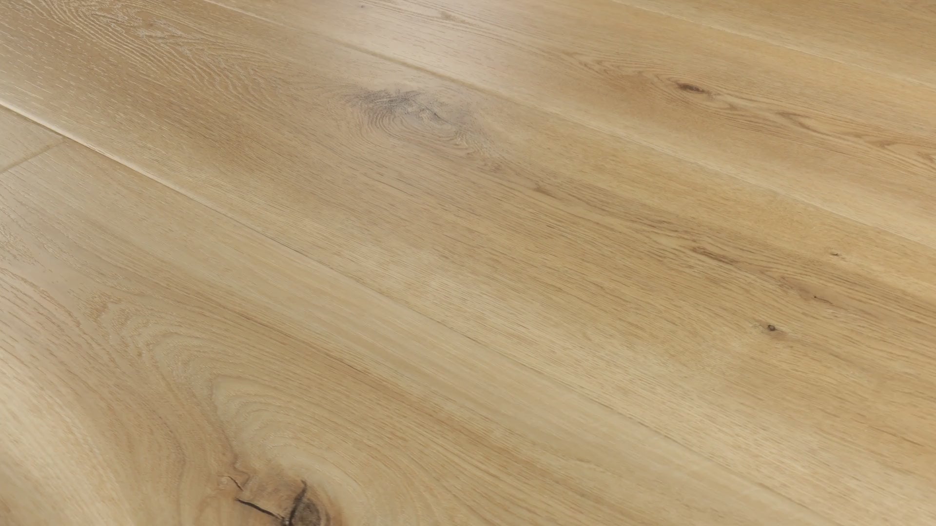 Close-up camera pans across COREtec Blonde Oak luxury vinyl plank flooring, highlighting warm blonde tones, natural wood grain, knots and wide planks.