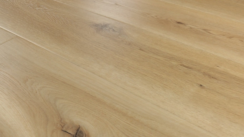 Close-up camera pans across COREtec Blonde Oak luxury vinyl plank flooring, highlighting warm blonde tones, natural wood grain, knots and wide planks.