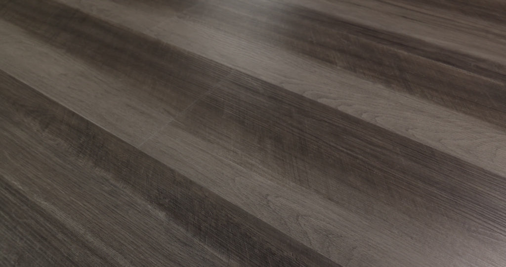 The darker streaks of Oyster Oak 0736V-00591 can add visual contrast in contemporary or industrial interiors. Oak-look grain runs through contrasting gray-brown bands along with Shaw Endura Plus embossed SPC vinyl planks that have a ScufResist finish, 7-by-48-inch dimensions, and 4.8 mm overall thickness. 