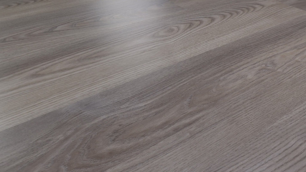 Gray blended with taupe gives Shaw Anvil Plus 20 Mil Grey Chestnut (2357V-07062) a subdued base for its bold looping grain. ScufResist is Shaw's specified finish for these micro-beveled vinyl planks. Transitional reading areas and contemporary rooms reflect the product imagery. See how Grey Chestnut's video informs your choice at Floor City.