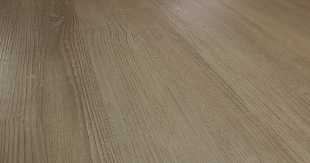 Soft taupe and muted brown tones give Shaw Floors Endura Plus Simple Wash a restrained wood appearance. Fine embossed grain meets lightly defined edges on 7-inch-wide, 48-inch-long vinyl planks. Their overall thickness is 4.8 mm, while the surface wear layer measures 12 mil. Japandi and Scandinavian minimalist interiors are possible settings for this understated design.