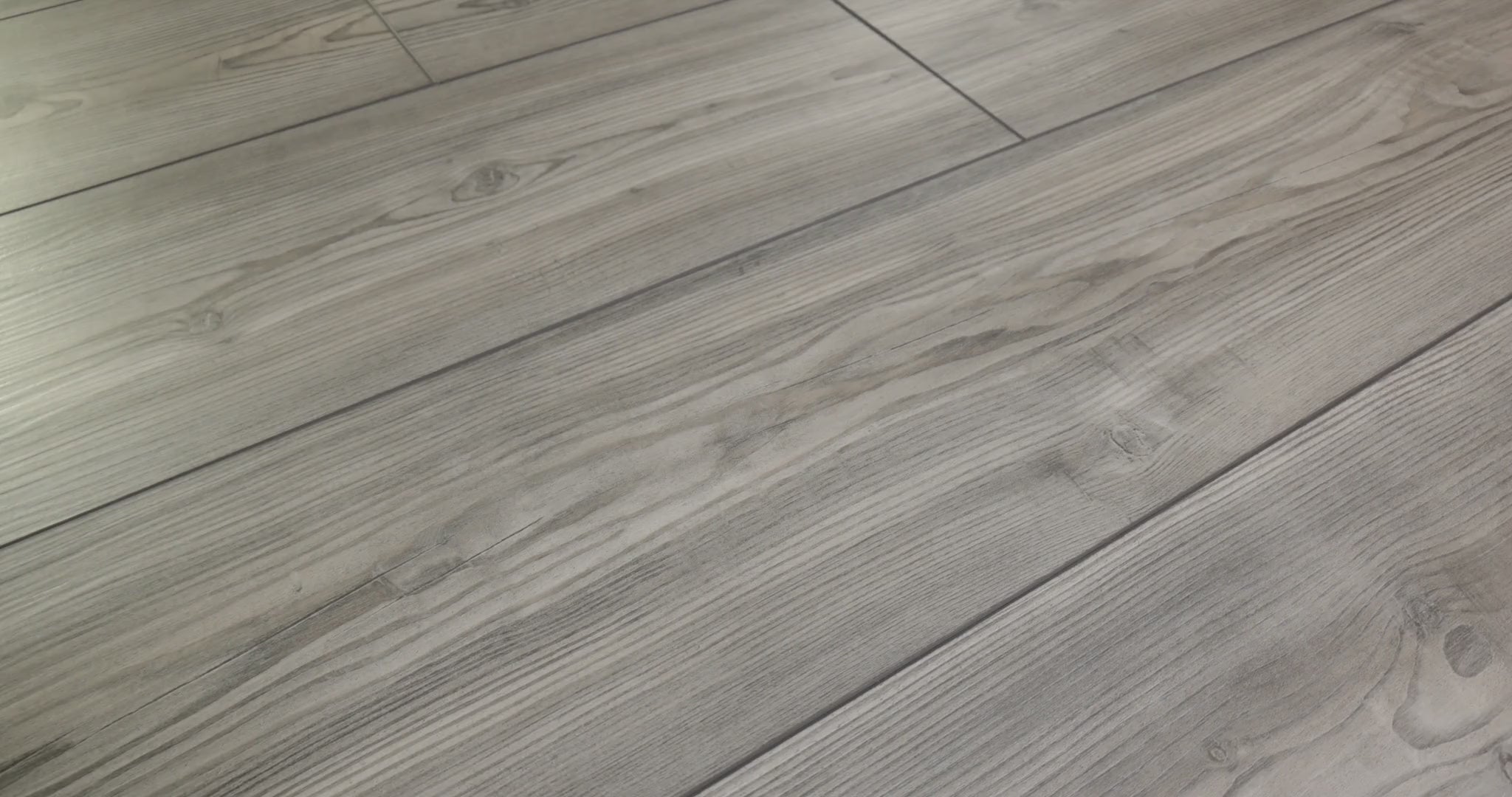 Distinct pine character appears in the long dark lines and knots of Shaw Paladin Plus Fresh Pine (0278V-05052), colored in cool gray. Painted bevels separate the vinyl planks; Shaw identifies the finish as ScufResist. Eclectic playroom styling and contemporary decor are grounded in the room photos.
