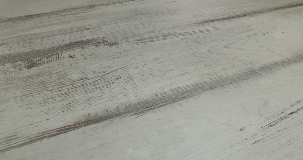 Compared with darker weathered wood looks, Shaw Endura Plus Fresh Driftwood appears pale gray with sharply contrasting brown-gray streaks. Its embossed, distressed-looking vinyl design comes in 7-inch-wide, 48-inch-long SPC planks with 4.8 mm thickness and attached EVA padding. Its pale, weathered appearance can support coastal cottage and modern farmhouse styling.