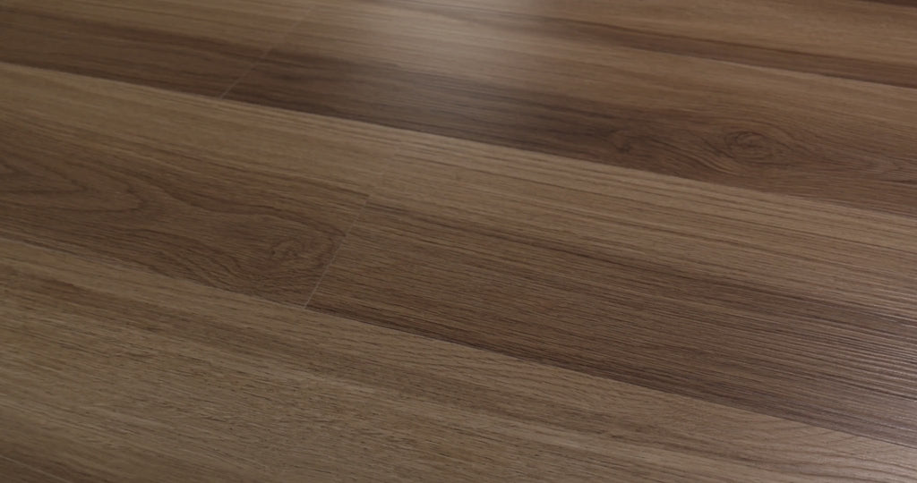 Small knot details and sweeping oak-pattern curves mark the beige-to-brown surface of Almond Oak. The embossed vinyl has a ScufResist coating and measures 7 inches wide by 48 inches long, with 4.8 mm plank thickness. Explore this look from Shaw Floorte Pro Endura Plus series for modern farmhouse or transitional home designs.
