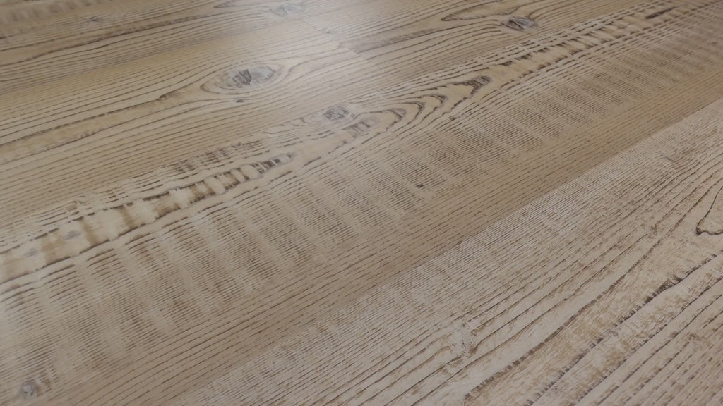 Saw-mark imagery and dark knots produce the visually textured pine look of Shaw Anvil Plus 20 Mil Accent Pine (2357V-07063). The video shows golden tan vinyl; Shaw verifies micro-beveled edges and a ScufResist finish. Transitional or contemporary styling follows the room references. Floor city ship nationwide.