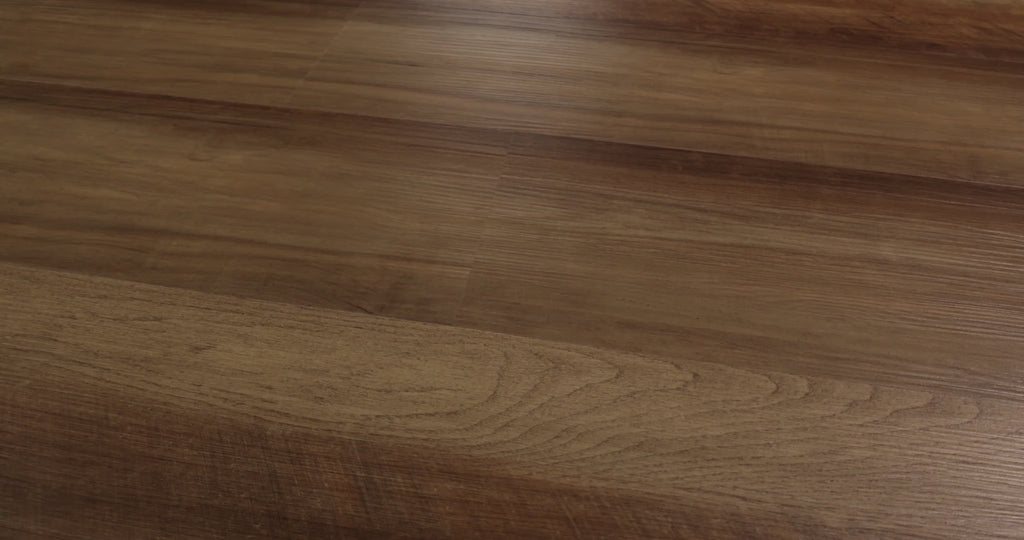 Textured oak-look grain follows golden brown areas and deeper brown streaks across Tawny Oak Shaw Endura 512C Plus. Attached EVA backing adds cushioning to its 4.8 mm SPC construction, supplied in 7-by-48-inch vinyl planks with small edge bevels. The varied warm coloring suits the visual character of Craftsman and traditional, rustic, or farmhouse interiors.