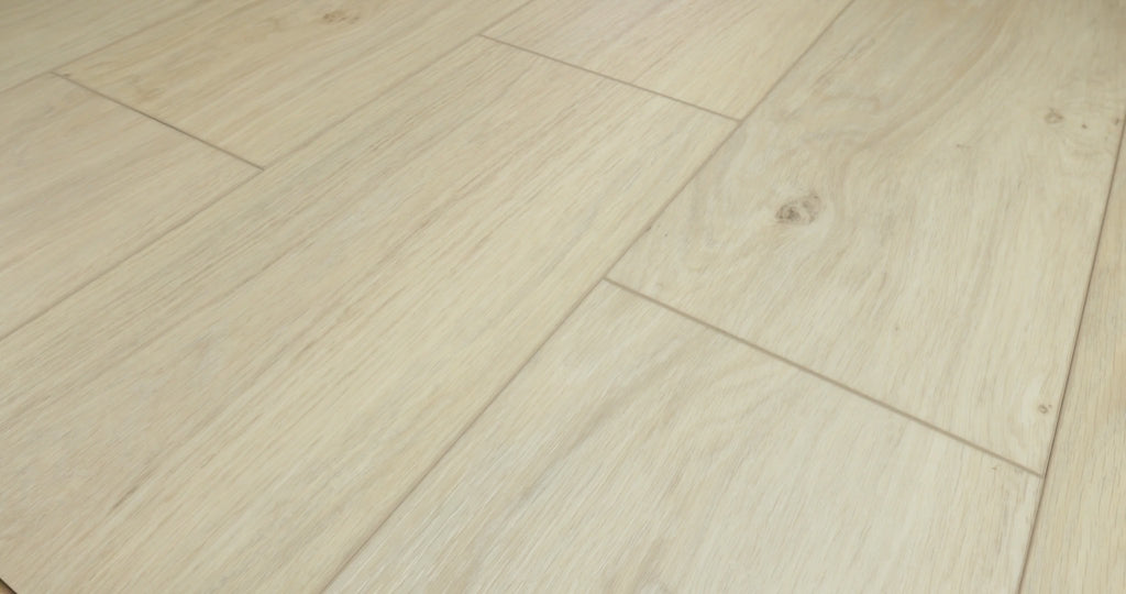 Close views of Wishbone White luxury vinyl flooring from Shaw Fresh Take, showing pale beige planks, flowing wood grain, small knots and visible joints as the viewing angle changes.