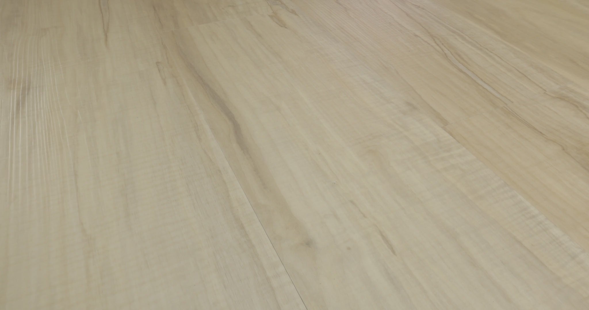 Fine embossed lines and narrow darker markings enliven the pale cream-beige  look of Spalted Maple. This Shaw Endura Plus luxury vinyl is 7 inches wide and 48 inches long, with 4.8 mm plank thickness and an attached EVA pad beneath its SPC core. Its appearance offers a flooring direction for Japandi minimalist and Scandinavian spaces.