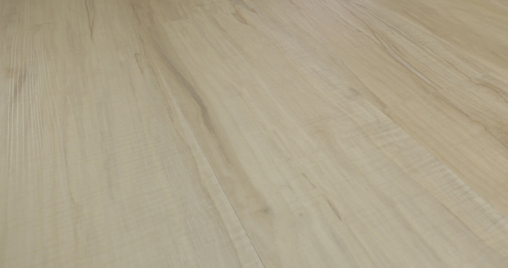 Fine embossed lines and narrow darker markings enliven the pale cream-beige  look of Spalted Maple. This Shaw Endura Plus luxury vinyl is 7 inches wide and 48 inches long, with 4.8 mm plank thickness and an attached EVA pad beneath its SPC core. Its appearance offers a flooring direction for Japandi minimalist and Scandinavian spaces.