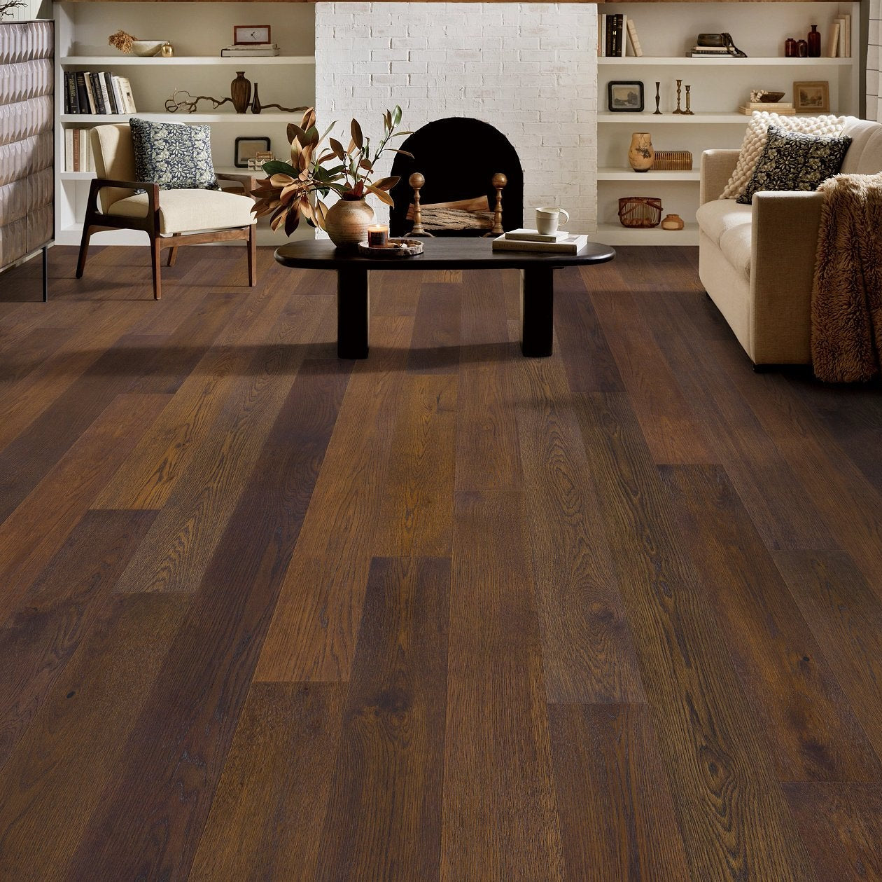 Living room view of Shaw Cornerstone II Clove 7 48 engineered hardwood flooring, showing natural wood hardwood color near sofa seating and the open floor area.